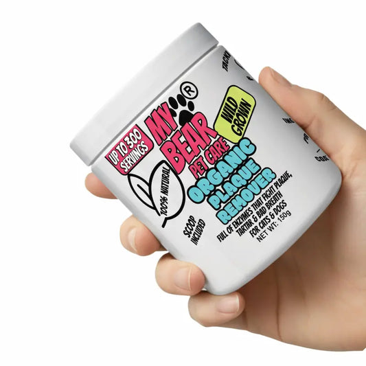 Hand holding a container of 'My Bear' pet care product with colorful text on a white background