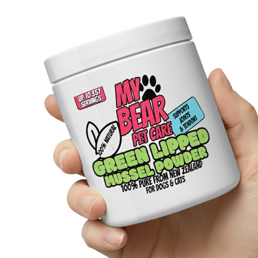 Hand holding a white container labeled 'My Bear Pet Care Green Lipped Mussel Powder' on a white background